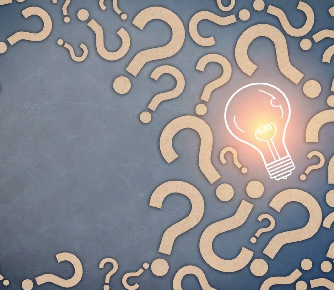 Question marks around a lightbulb